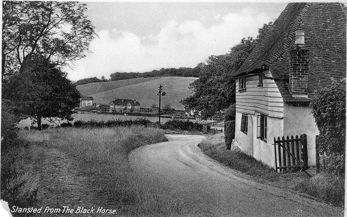 Historic postcard: Stansted village viewed from The Black Horse